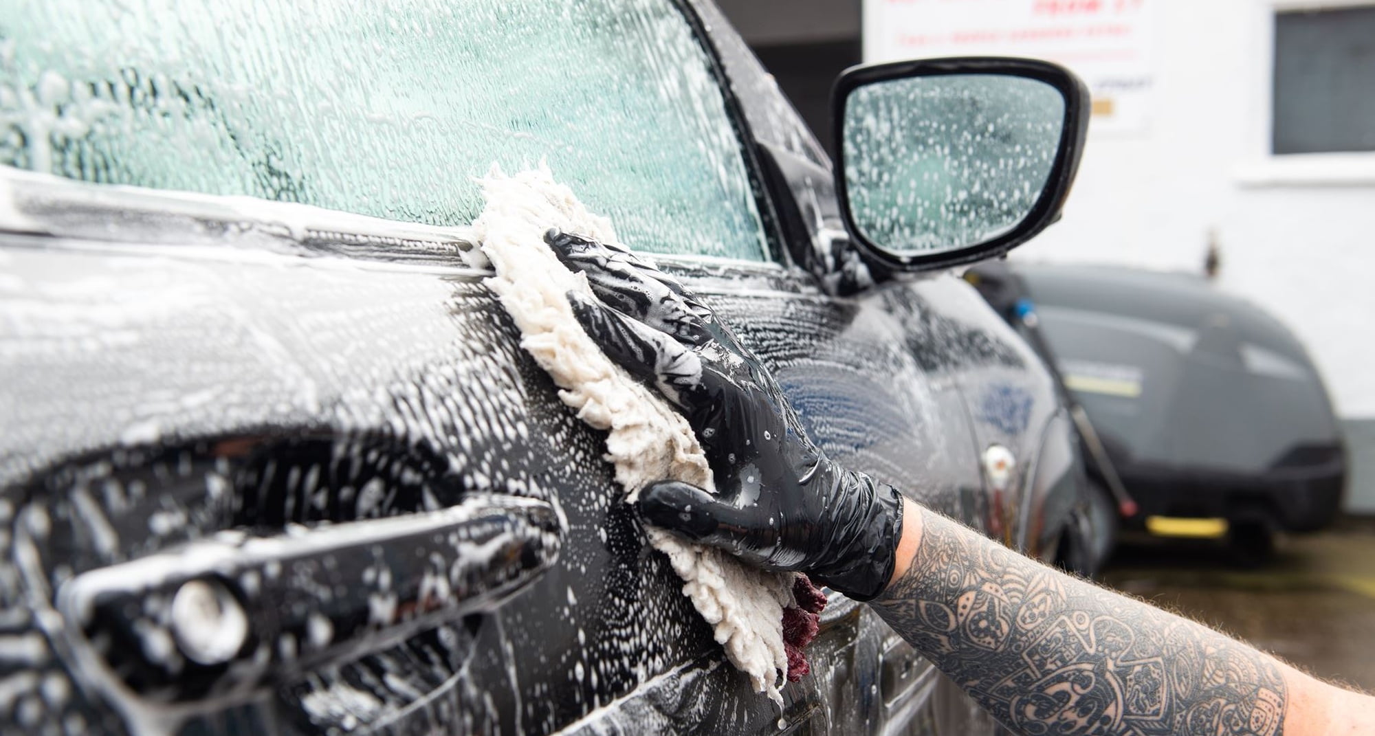 Car being washed by hand and soap